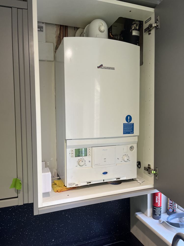 Worcester combi boiler installed neatly inside a kitchen cupboard
